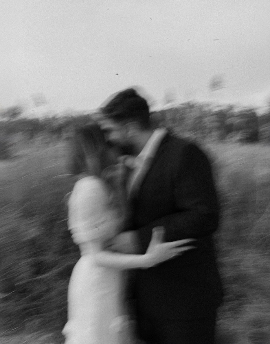 A couple holding each other close, caught in motion blur