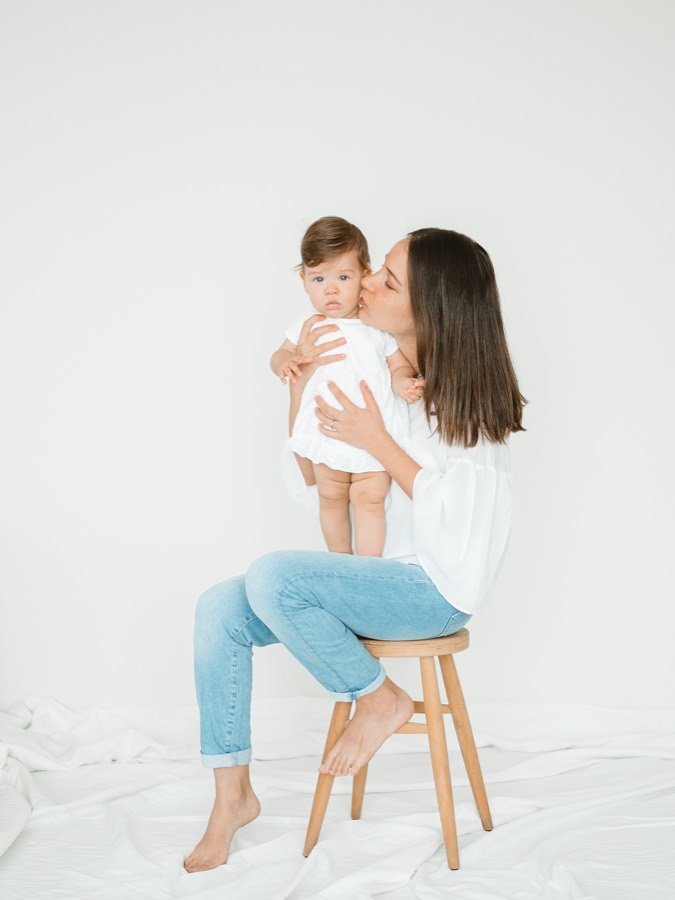 A mother lifting her baby in the studio