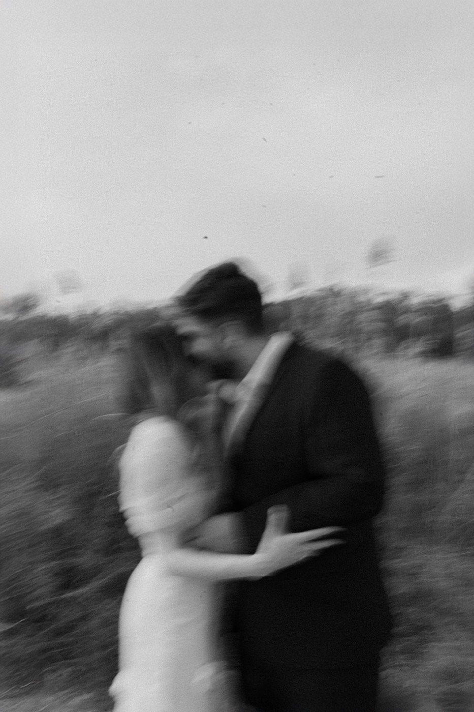 A couple holding each other close, caught in motion blur